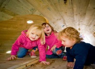 children inside playhouse at Westonbirt