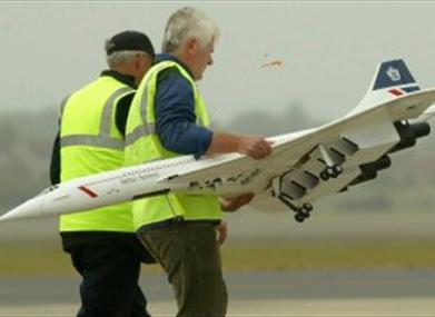 Two men with model of Concorde