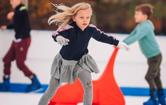 A small child ice skating