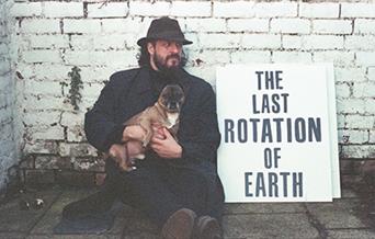 Brian Christinzio  holding a dogsitting beside a sun that says:  The last rotation of Earth.