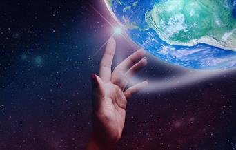 Hand reaching through space for the Earth