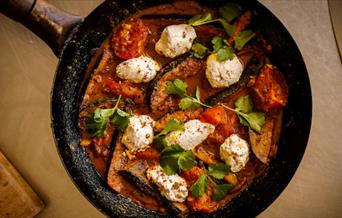 An aubergine curry in a frying pan