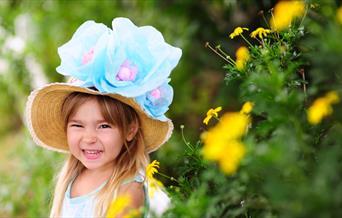 A young girl wearing an Easter bonnet