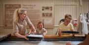 Children making paper at Wookey Hole