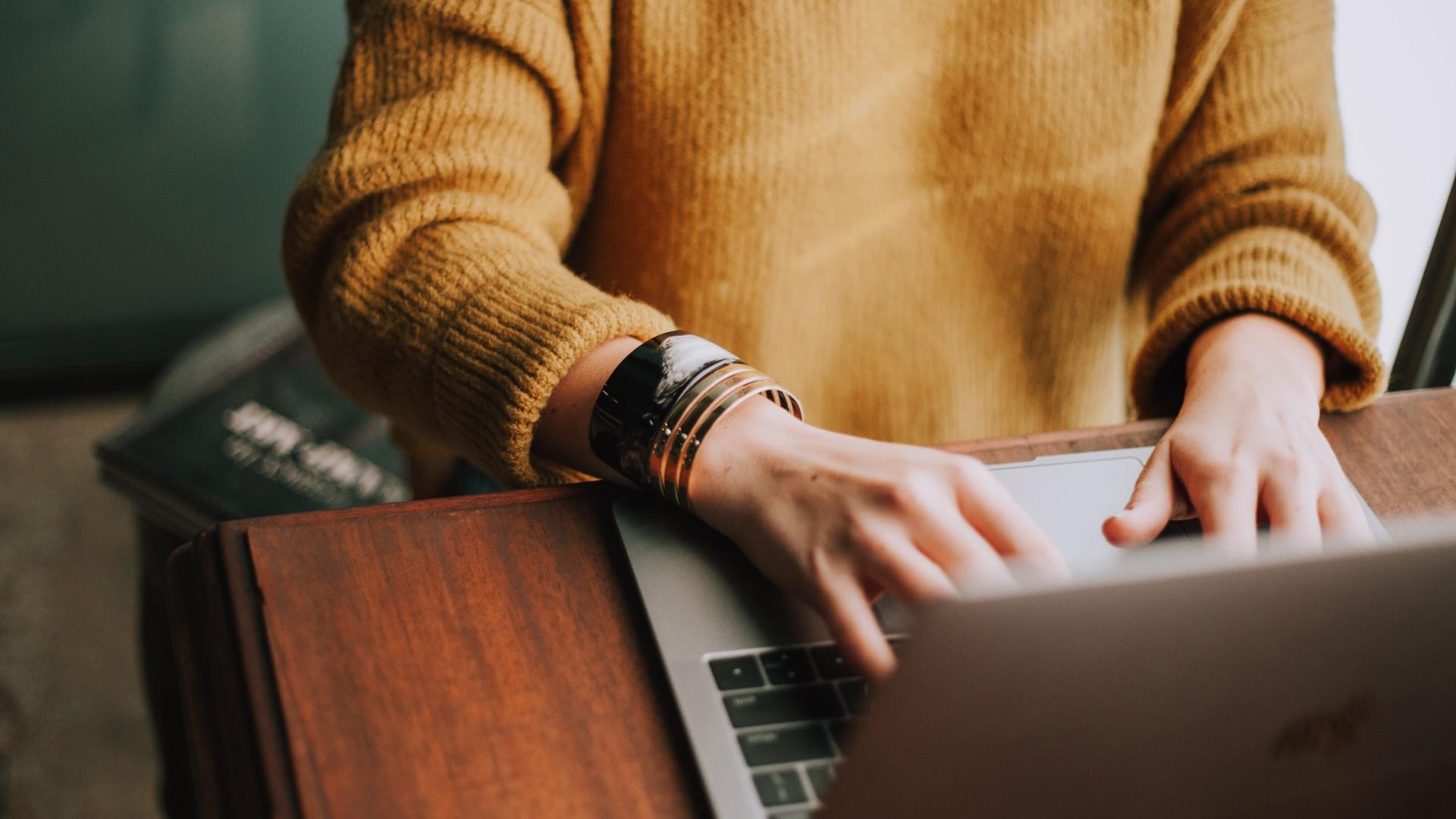 Laptop and Woman with Yellow Jumper