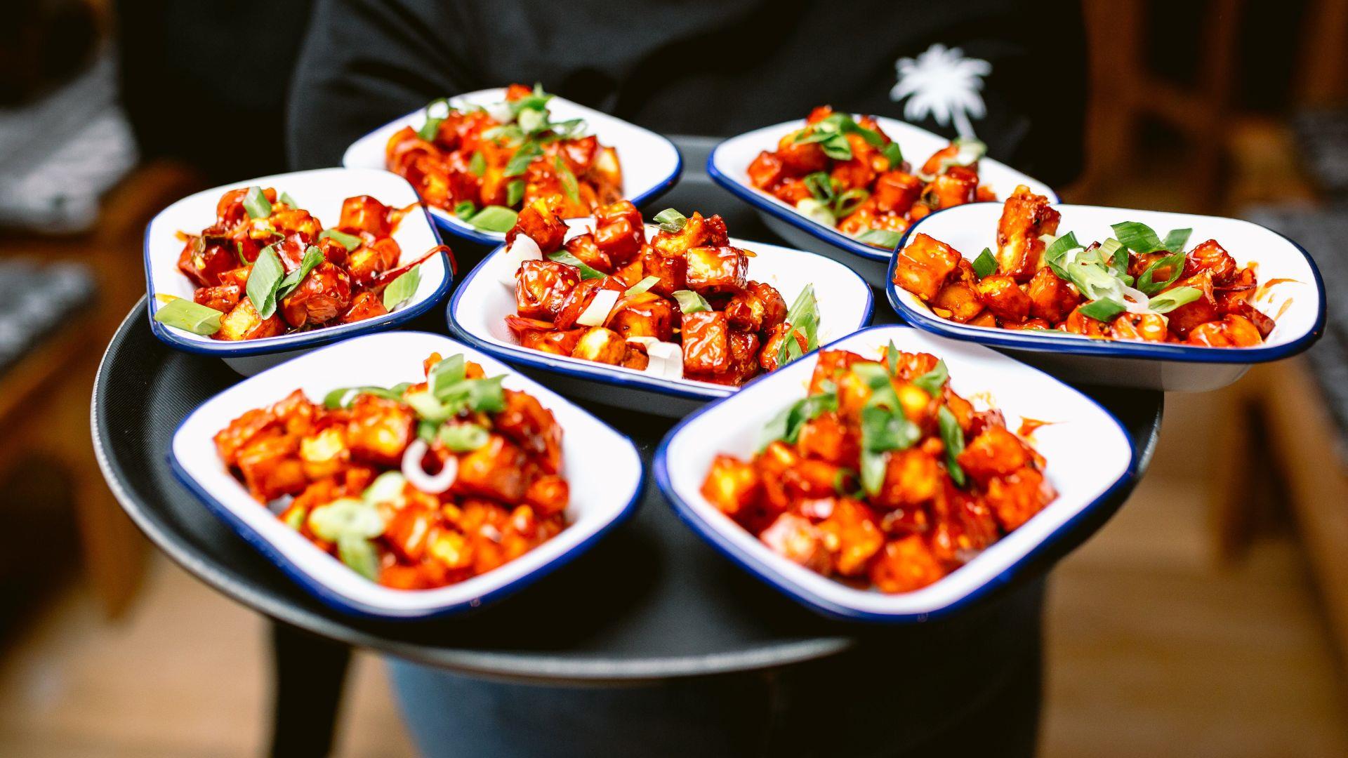 Man holding trays of food