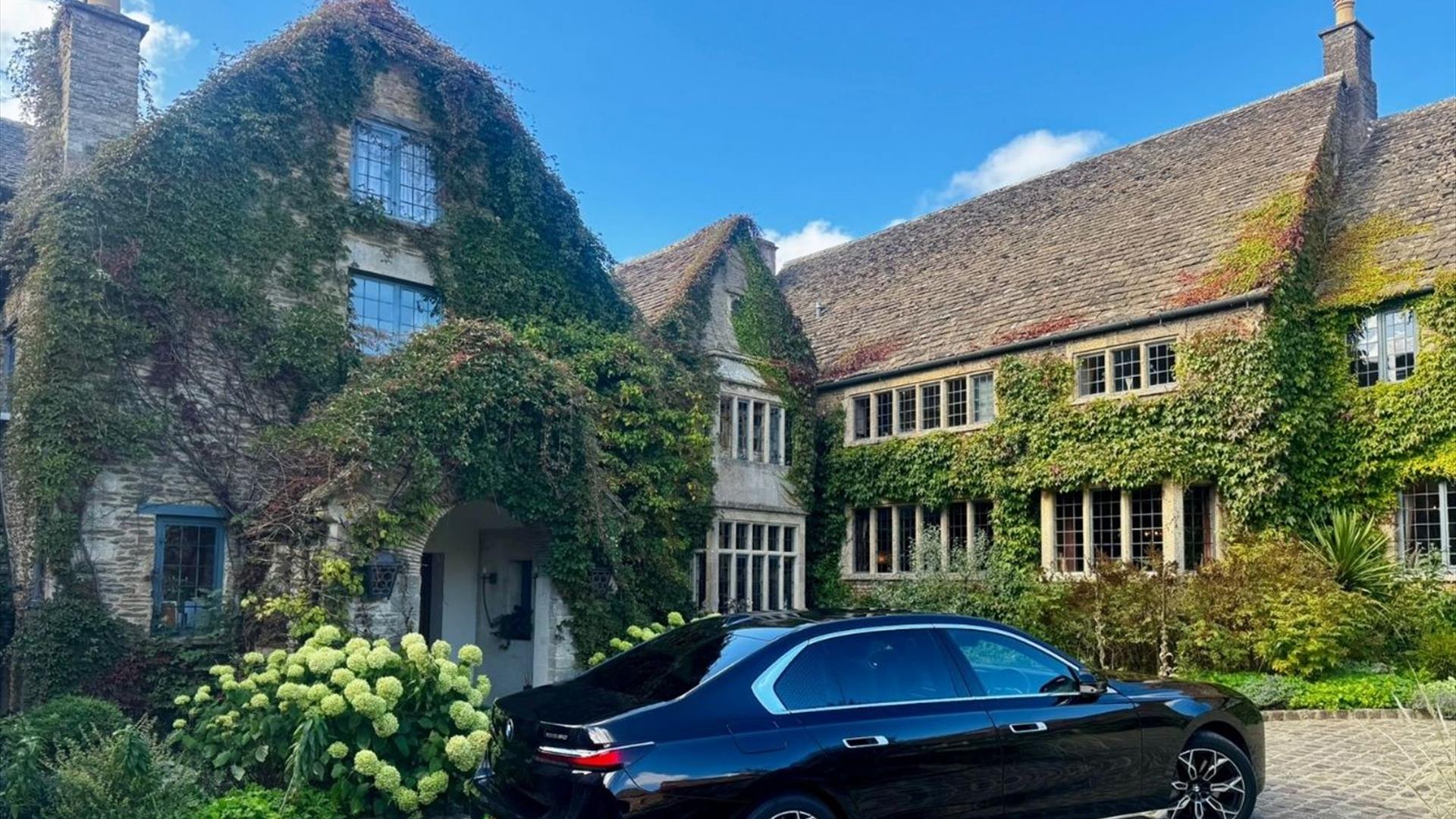 Car outside Cotswolds manor house