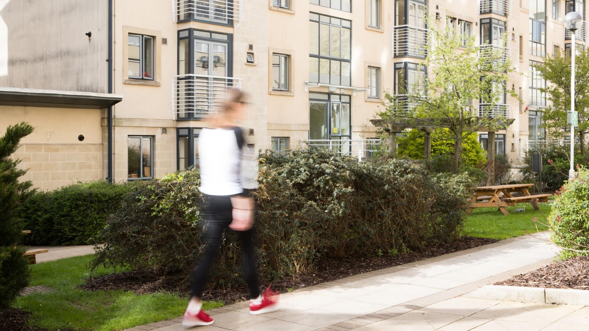 Student walks across University Campus