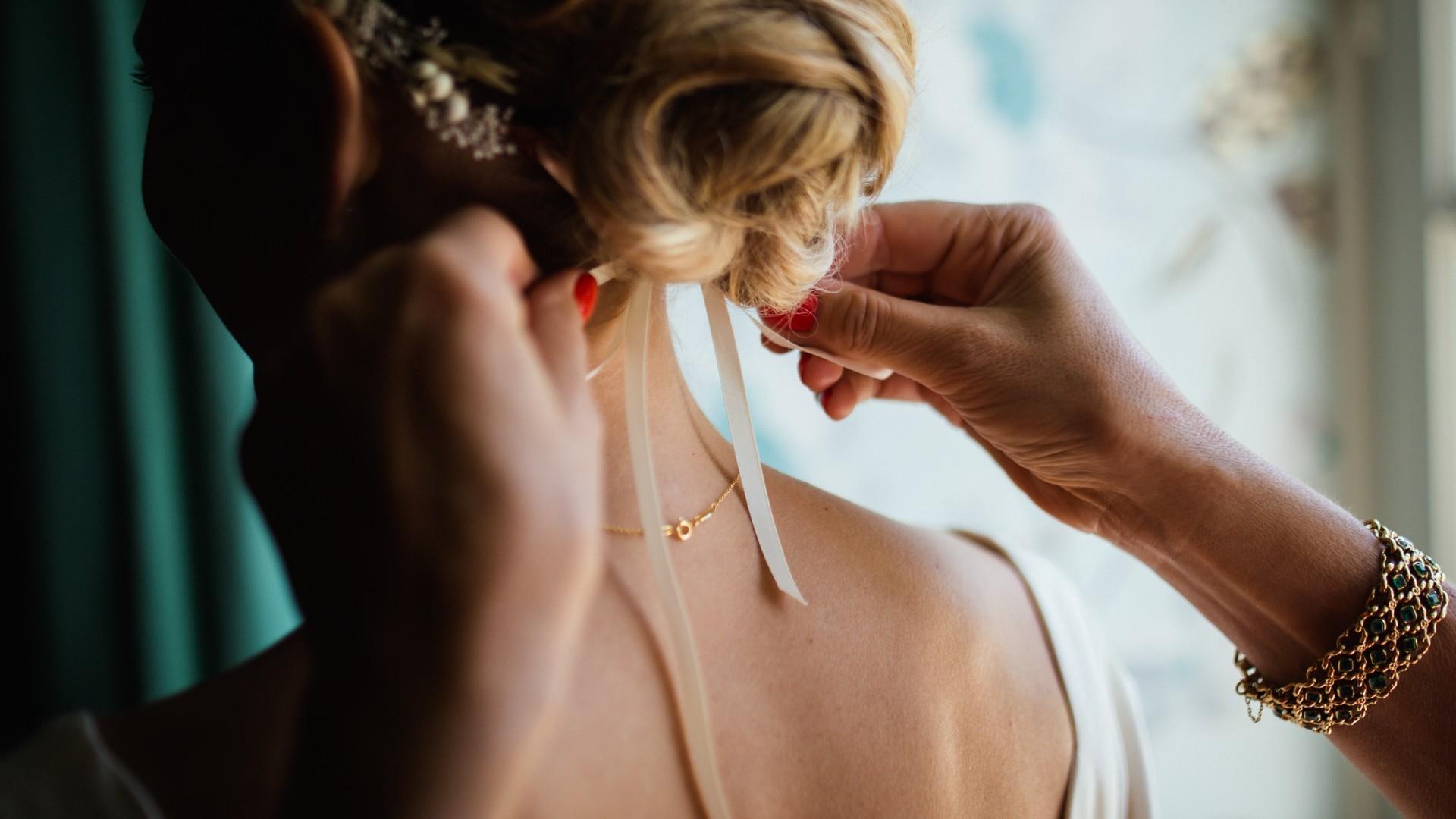 Bride prepares hair