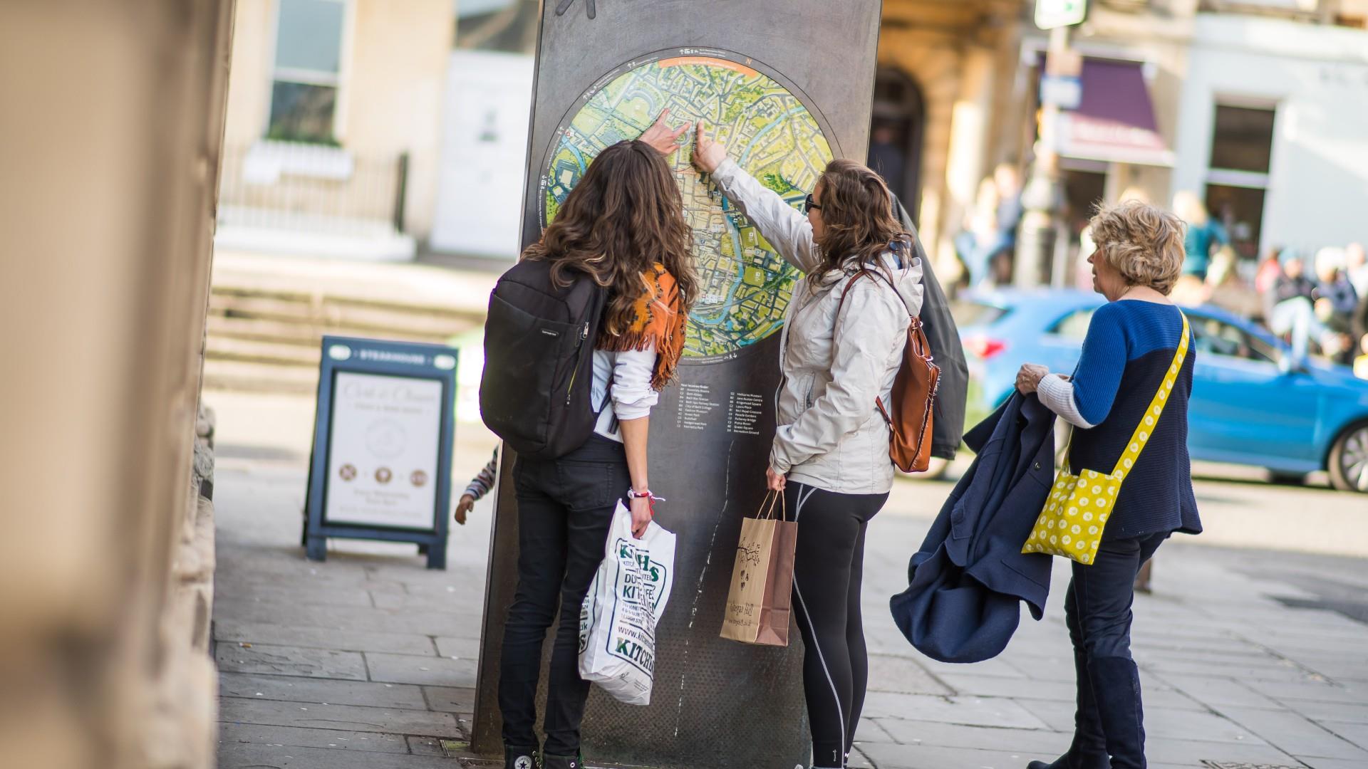 Group of women read street map