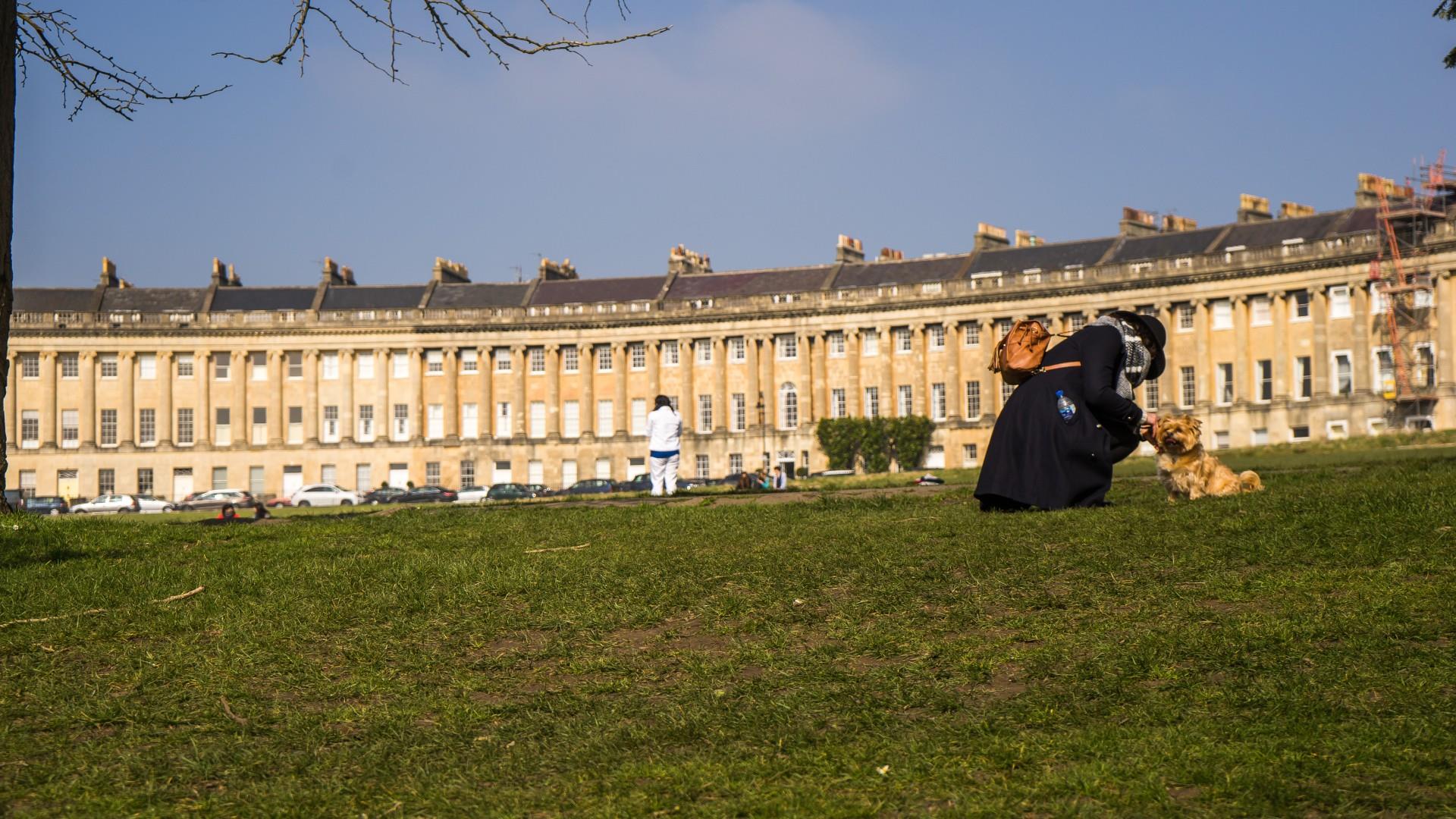 Owner pets dog on Royal Crescent