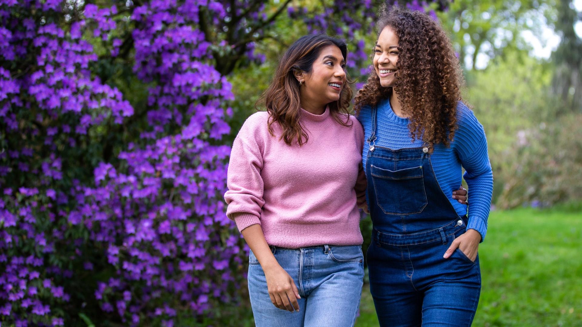 Two women walking between trees at Westonbirt Arboretum, near Bath.