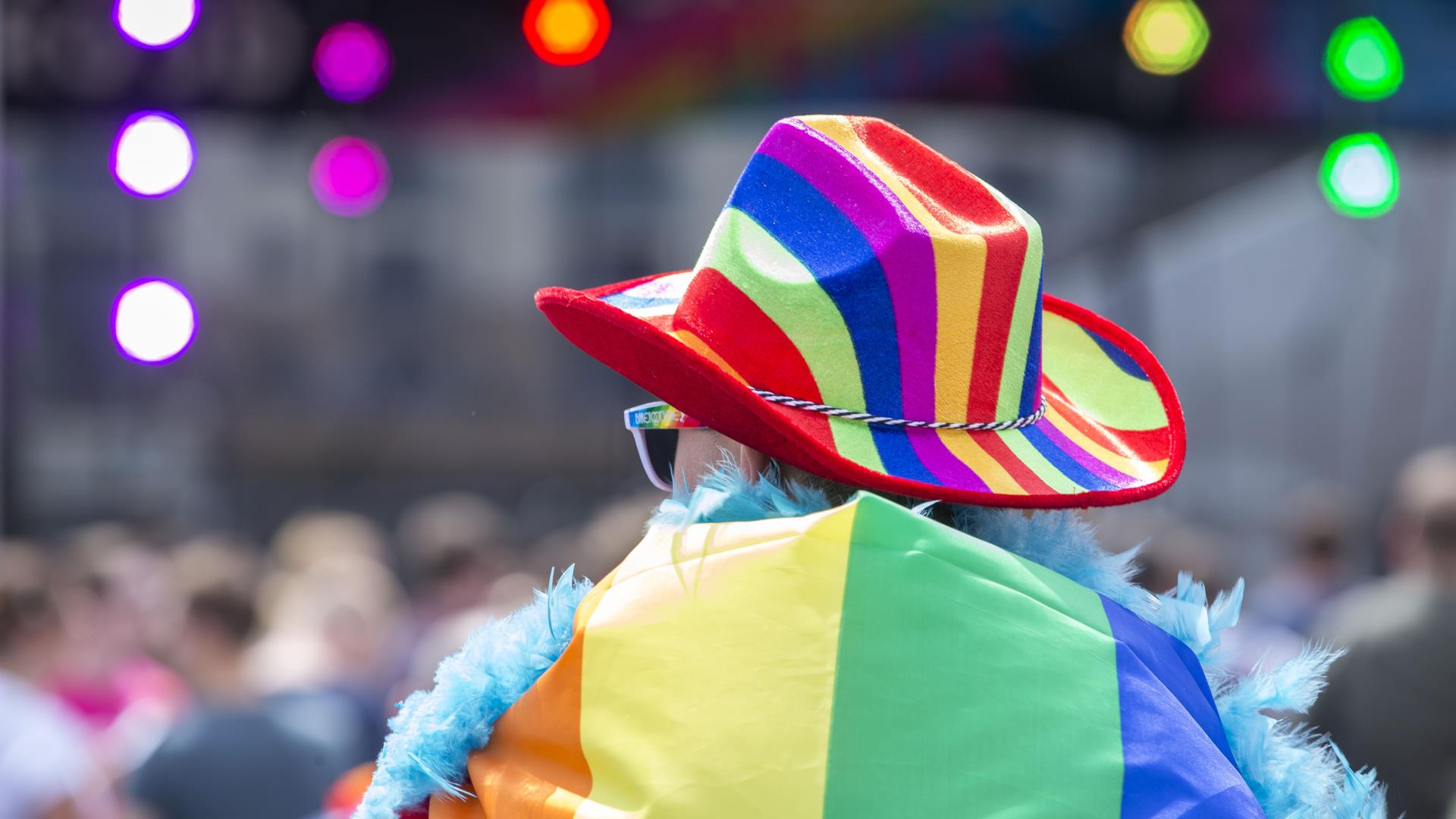 Man in rainbow hat with flag