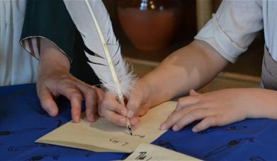 Writing with a quill and ink