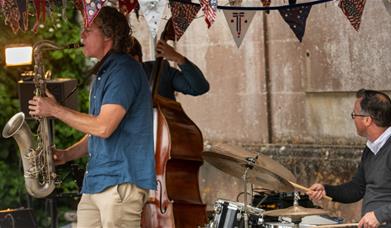 John Martin and band playing on a garden terrace