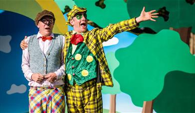 Two actors perform on stage