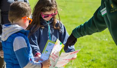 Children looking at Easter trail sheets