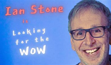 Smiling portrait of Ian Stone on a blue background with the text "Ian Stone is Looking for the Wow".