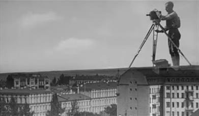 Black and white picture of man with camera