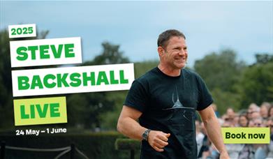 Steve Backshall talking into a microphone in front of an audience