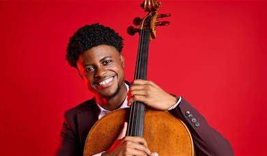 Man holding the neck of a cello