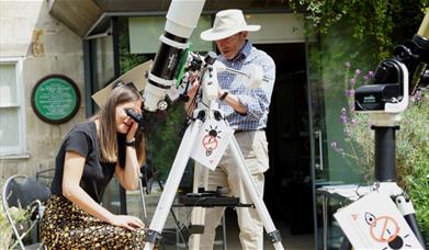 People looking through telescopes in the Herschel garden