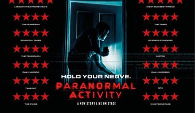 A man shines the light from his phone camera into an ominous room. 