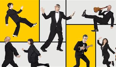 A variety of men and women strike poses with ukuleles. 