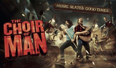 A group of male friends are singing and dancing around a bar with the words 'THE CHOIR OF MAN' displayed.