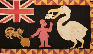 Brightly coloured flag including a pelican and a fish