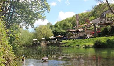 Outdoor seating along the riverside at Cross Guns at Avoncliffe