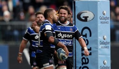 Ollie Lawrence of Bath Rugby celebrates his try against Saracens with teammate Tom de Glanville.