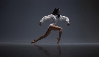 A ballerina with contemporary-style clothing and hair poses. 