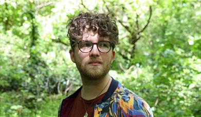 an image of headliner Tom Denbigh