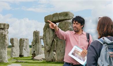 Jules presenting to his tour group in front of Stonehenge