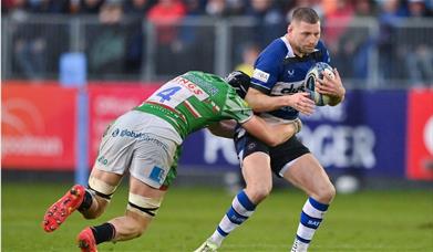 a man playing rugby being tackled