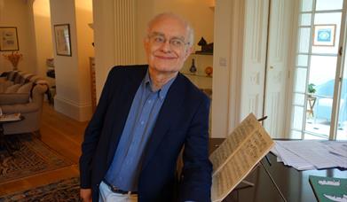A man leaning on a piano