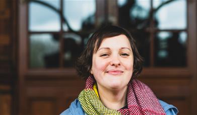 Headshot of Josie Long smiling to camera.