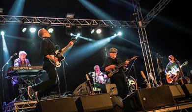 Two men with guitars on a stage