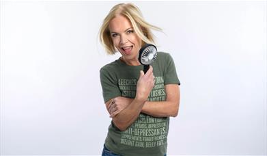 A photo of Mariella Frostrup holding a fan 