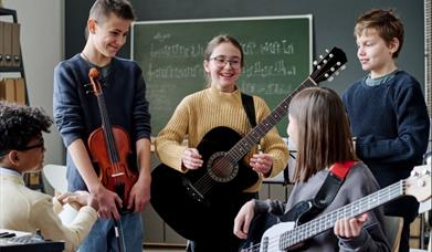 children holding guitars