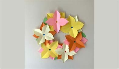 A wreath made out of paper with flower shapes