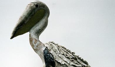 A sculpture of a pelican in clay