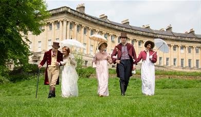 A grpoup of people wearing Regency costume at the Royal Crescent in Bath 