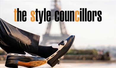 A photo of a a pair of legs in a pair of smart black trousers and shoes 