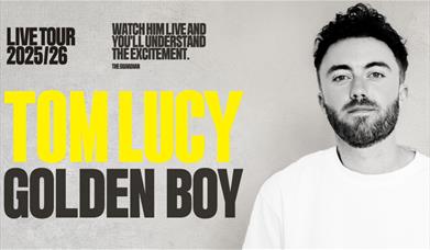 A poster advertising the show 'Tom Lucy: Golden Boy' at Komedia Bath