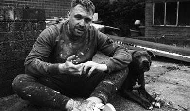 Man on a building site with dog