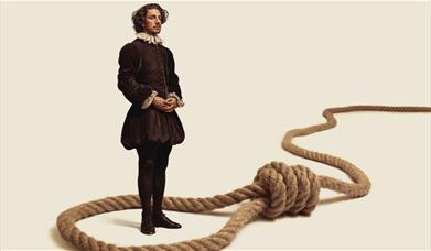 A man in 1500's attire stands in the middle of a loop with a running knot (noose).