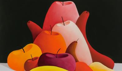 Red, pink, orange and yellow fruit on a grey and black background