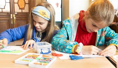 Two girls working on art activities at the Victoria Art Gallery